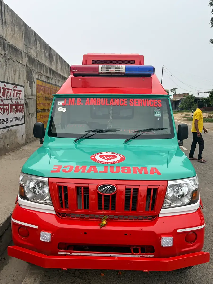 Front of a JMB Bolero ambulance with JMB Ambulance Services sign