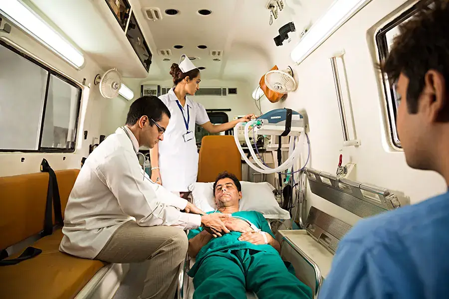 Medical team attending a patient inside a ventilator ambulance